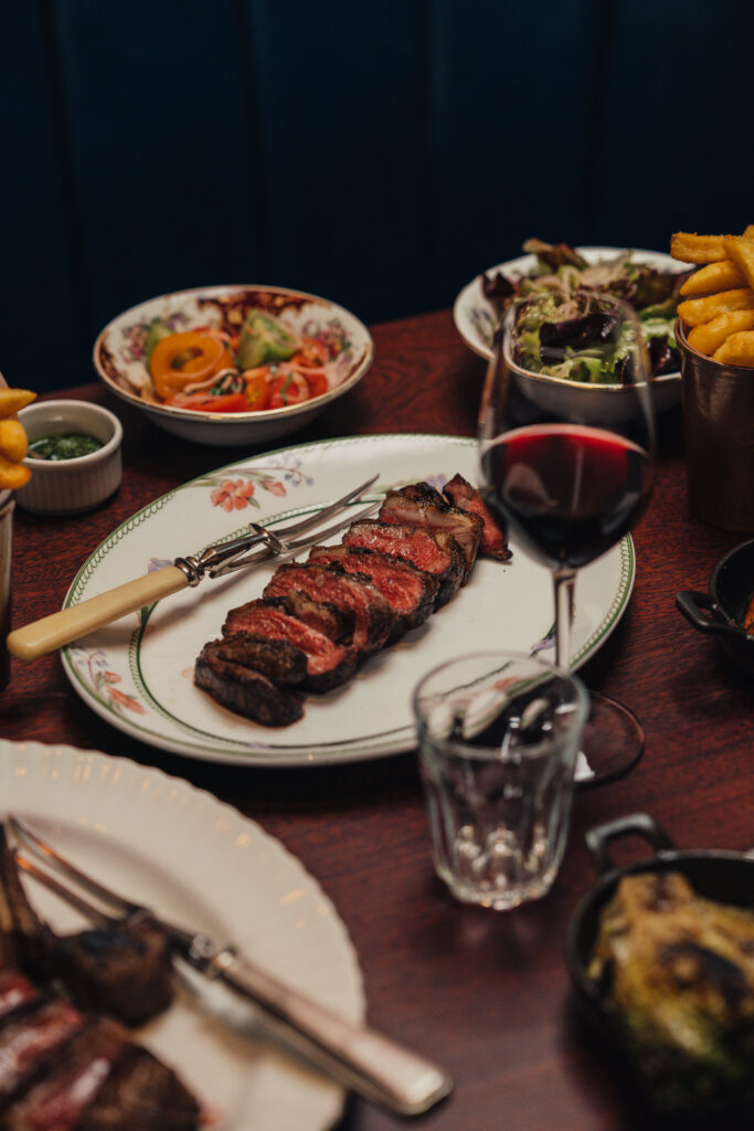 Lamb rump on a busy table of food